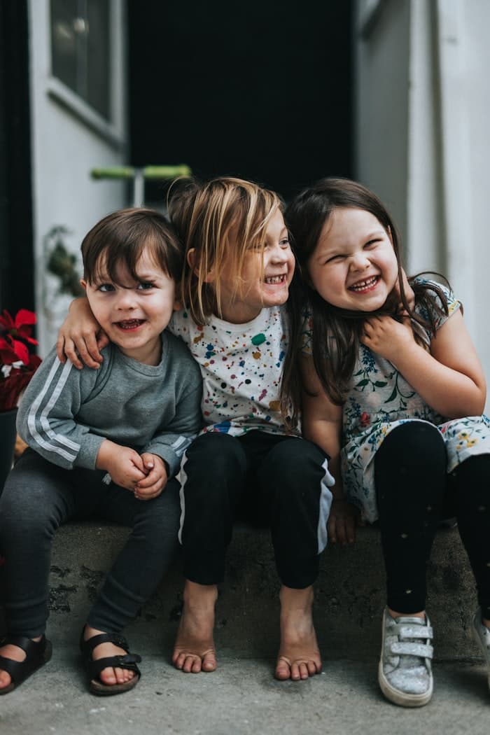 Children smiling together before a family activity